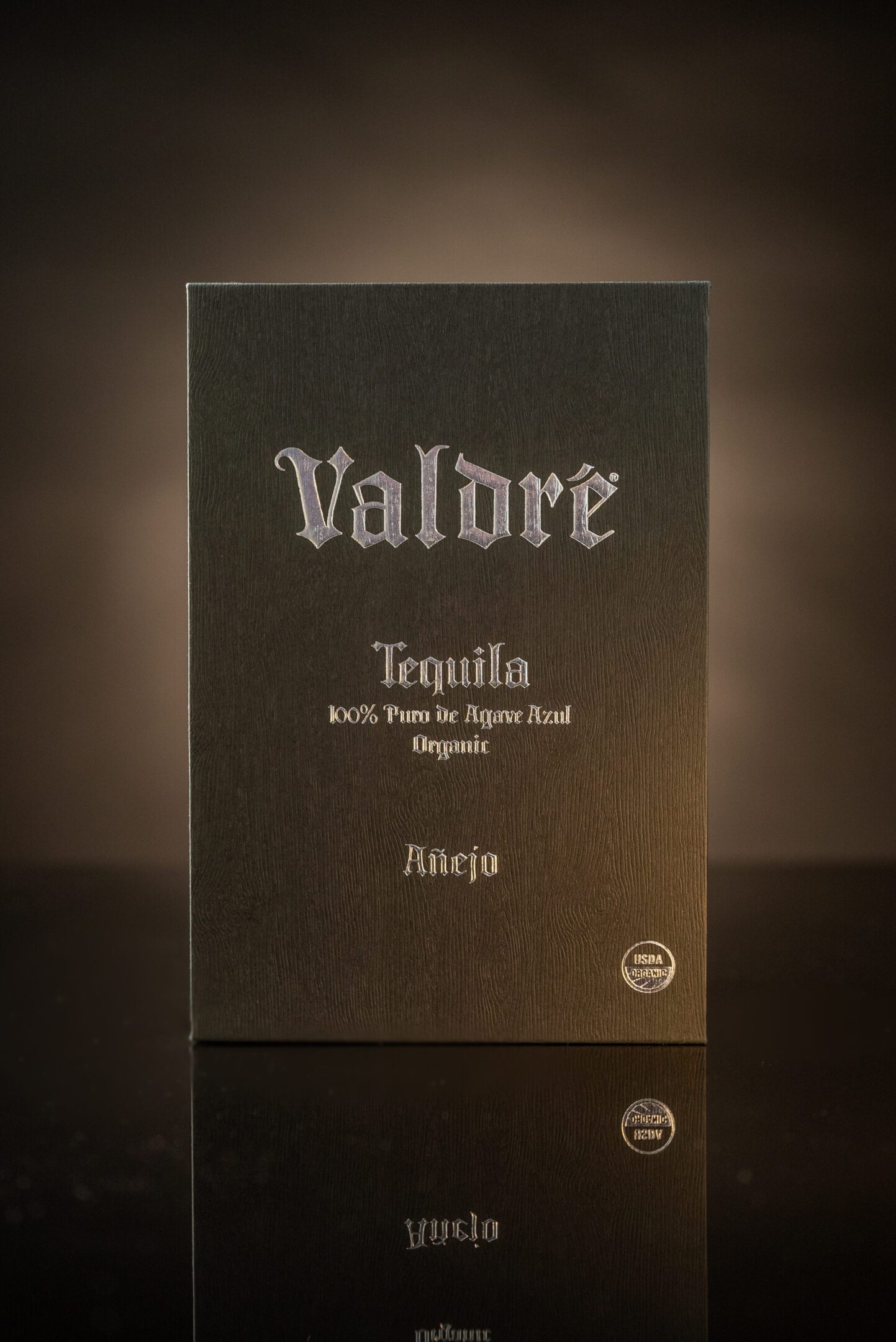 A black and white photo of a bottle of tequila.