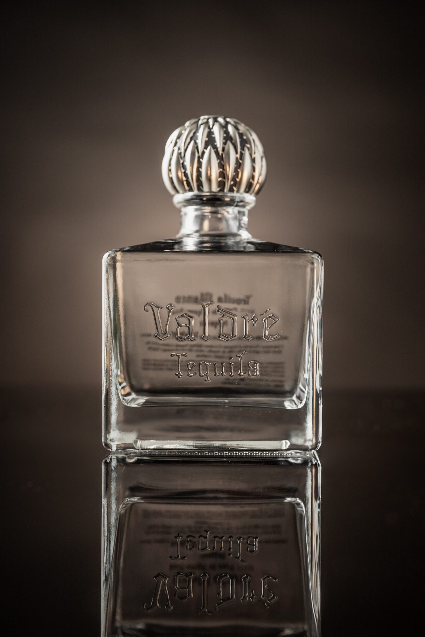 A bottle of perfume sitting on top of a table.