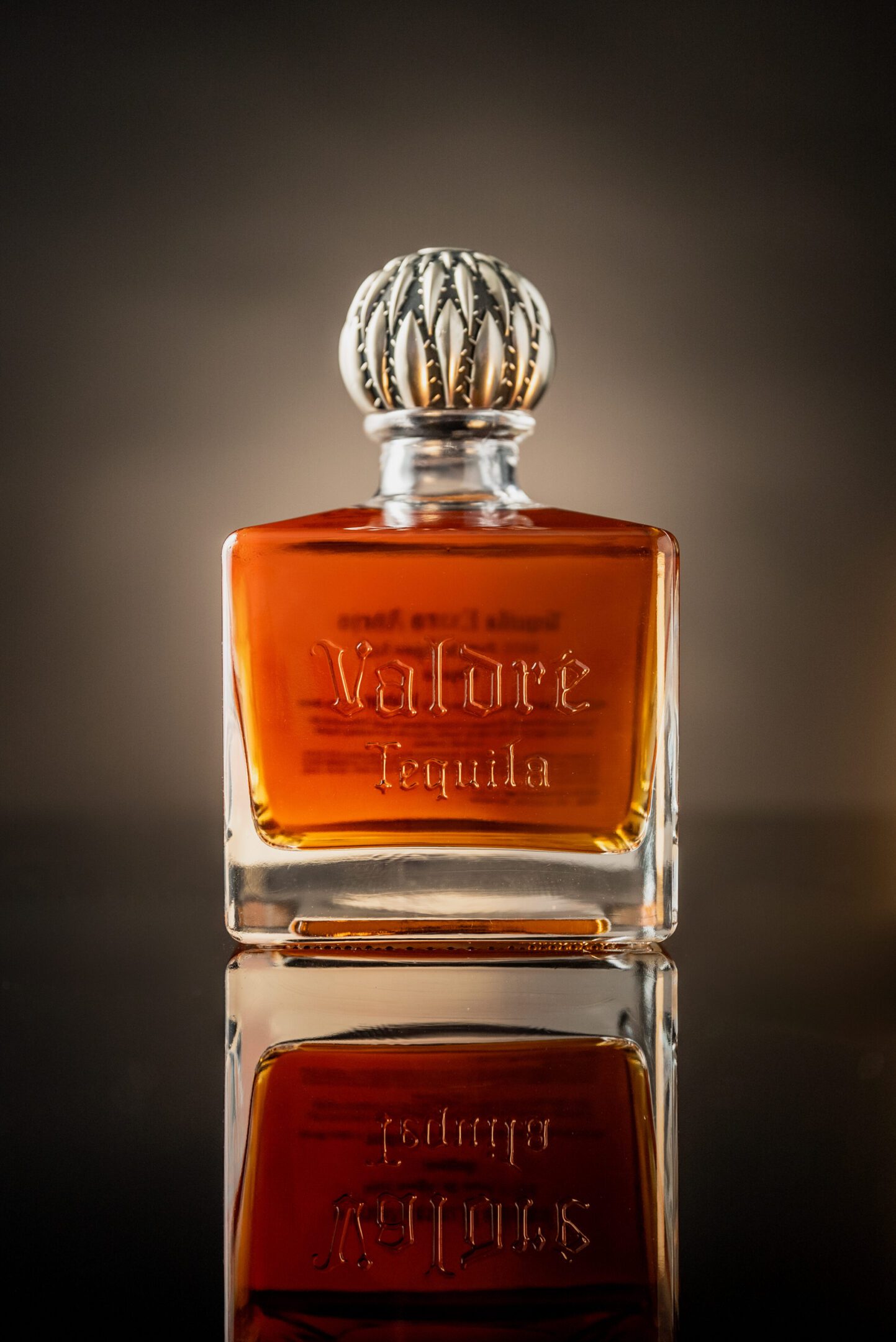 A bottle of perfume sitting on top of a table.